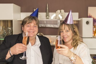 Close-up portrait of couple drinking champagne at party