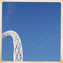 Low angle view of trees against clear blue sky