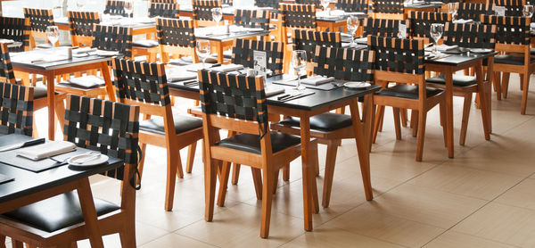 Empty chairs and tables in restaurant