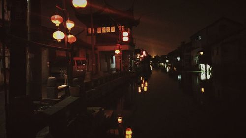 Illuminated lanterns hanging in city at night