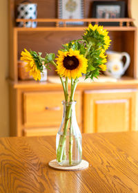 Close-up of yellow flower vase on table