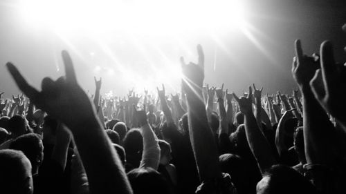 Crowd with arms raised in concert
