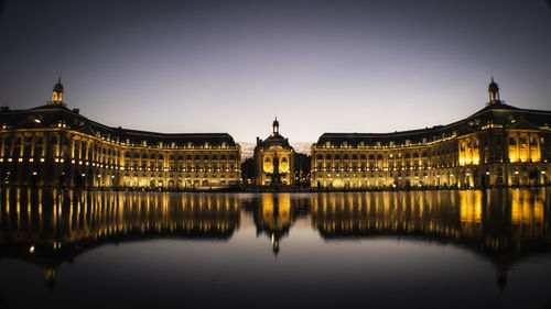 Reflection of illuminated buildings in water at night