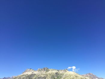 Scenic view of mountains against clear blue sky