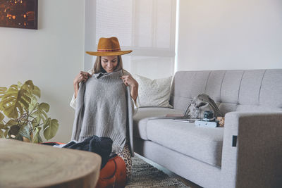 Portrait of young woman standing at home