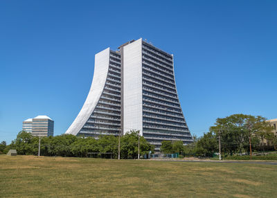 Low angle view of modern buildings against clear blue sky