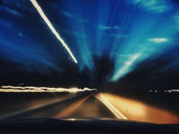 Road passing through tunnel at night