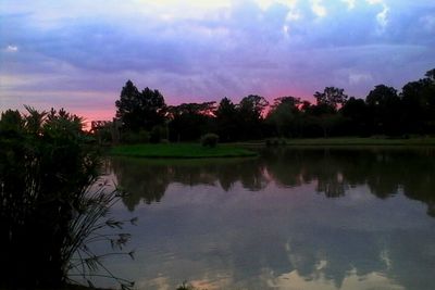 Reflection of trees in lake against sky during sunset