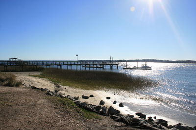 Pier over sea against clear sky