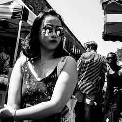 Portrait of young woman looking away outdoors