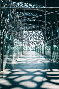 Walkway amidst buildings in city