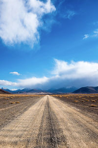 Dirt road along countryside landscape