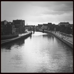 Bridge over river with buildings in background