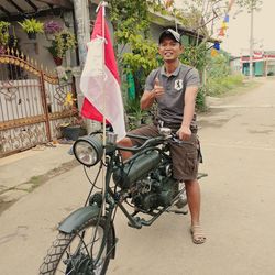 Rear view of man riding bicycle on road