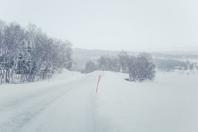 Snow covered field against sky