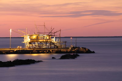 Scenic view of sea against orange sky