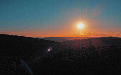 Scenic view of mountains against sky during sunset