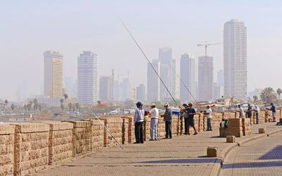 People fishing on bridge