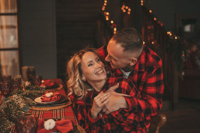 Candid authentic happy married couple spends time alone at lodge xmas decorated