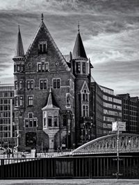 View of buildings against cloudy sky