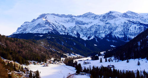 Scenic view of snow covered mountains against sky