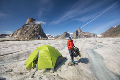 Mountaineer in mountain landscape, baffin island, canada.