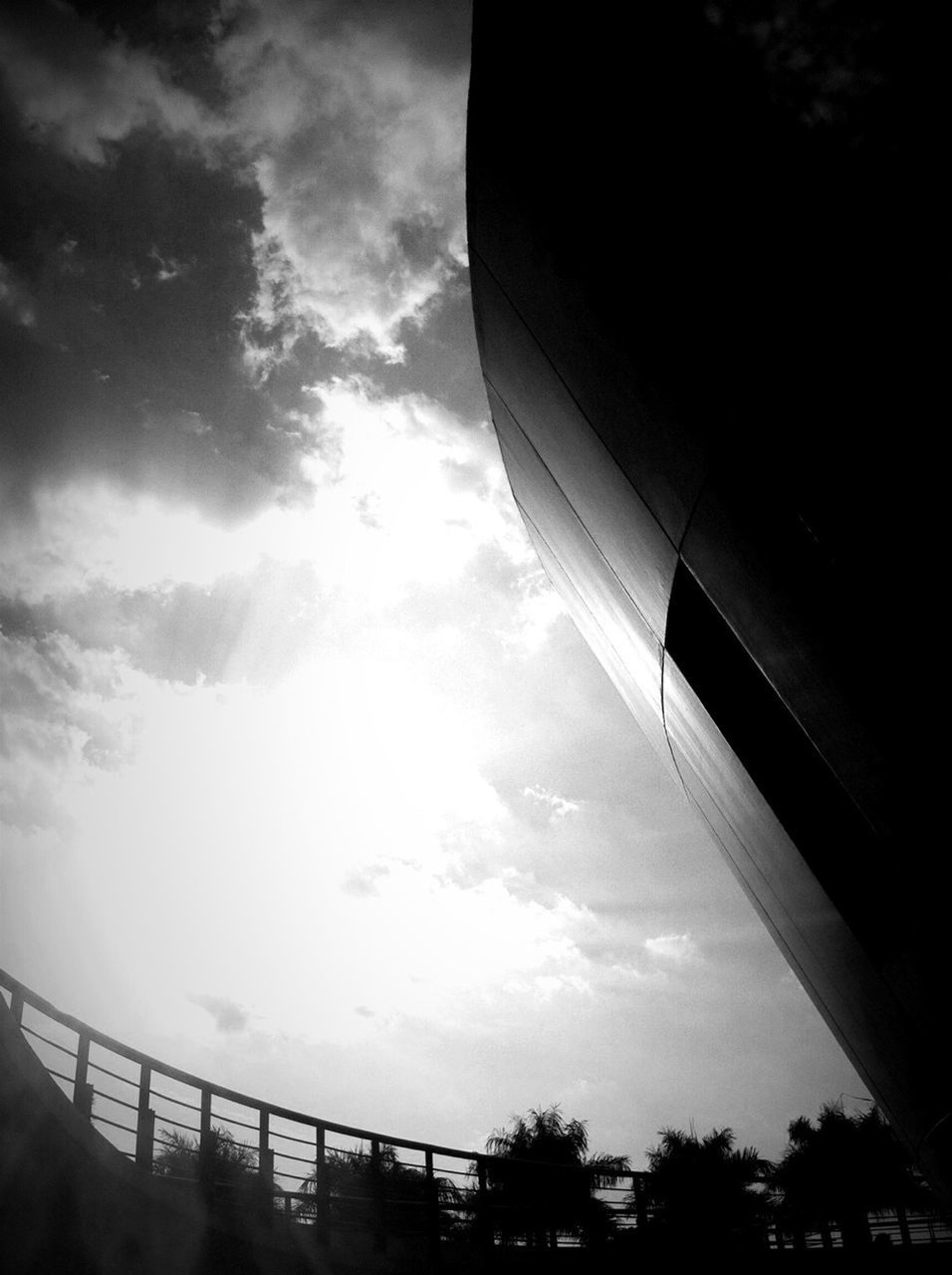 transportation, sky, airplane, cloud - sky, mode of transport, low angle view, air vehicle, part of, cropped, cloud, flying, aircraft wing, sunlight, cloudy, travel, journey, glass - material, silhouette, on the move, day