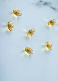 High angle view of pills on white background