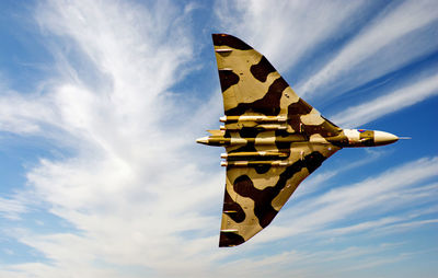 Low angle view of airplane flying against sky