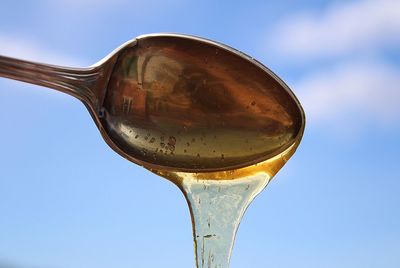 Honey dripping from a spoon