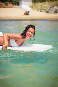 Young beautiful woman having fun swimming in the sea