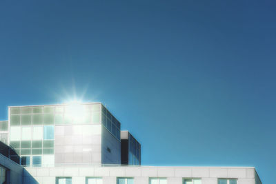 Low angle view of buildings against clear blue sky