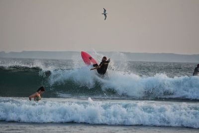 People surfing in sea