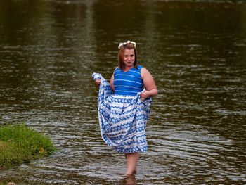 Portrait of smiling woman standing in river