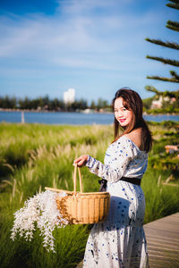 Young woman smiling while standing on field