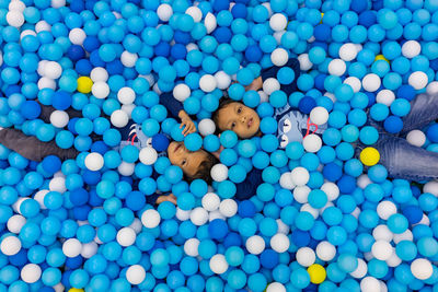 Portrait of siblings amidst balls