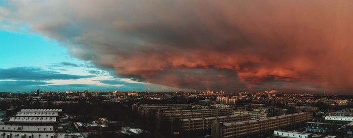 Scenic view of storm clouds over cityscape