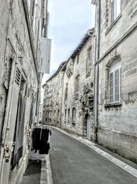 Street amidst buildings in city against sky