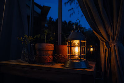 Illuminated lamp on table in building