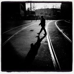 Woman walking on road in city