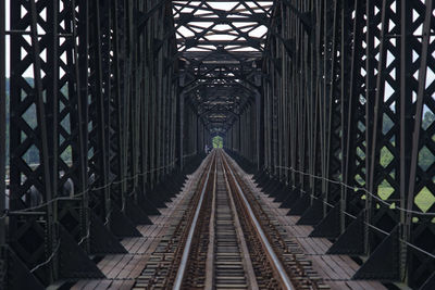 Railroad tracks amidst bridge