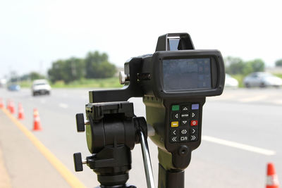 Close-up of camera on road against sky