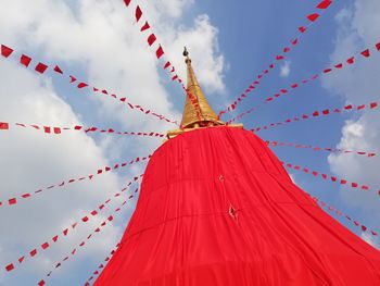 Low angle view of red umbrella against sky