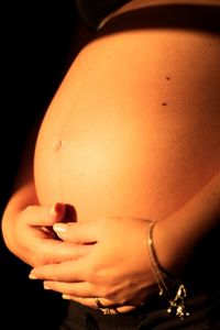 Cropped image of woman over black background