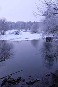 Scenic view of lake against sky during winter