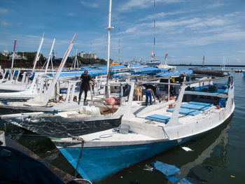 Boats moored at harbor