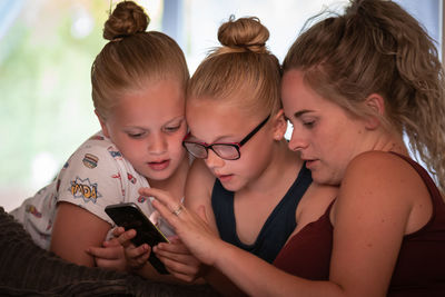 Girl and woman using mobile phone