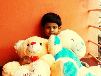 Portrait of boy with toy at home