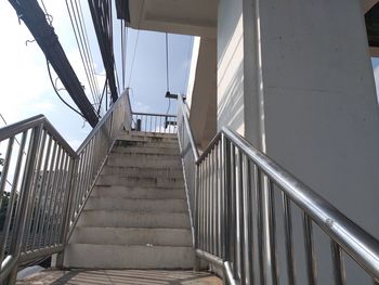 Low angle view of staircase by building against sky