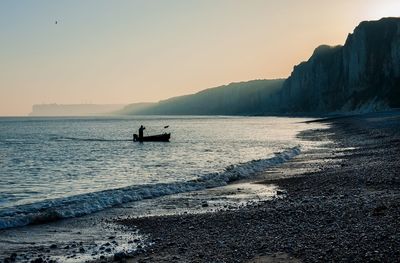 Scenic view of sea against clear sky during sunset